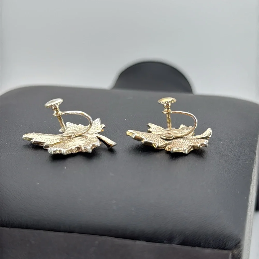 Gold tone textured leaf rhinestone accent screw back statement earrings